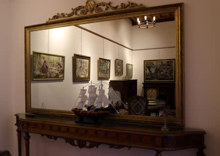 Paintings are reflected in a mirror at the art gallery and cultural centre in the old city of Tripoli, Libya April 23, 2019. Picture taken April 23, 2019. REUTERS/Ahmed Jadallah