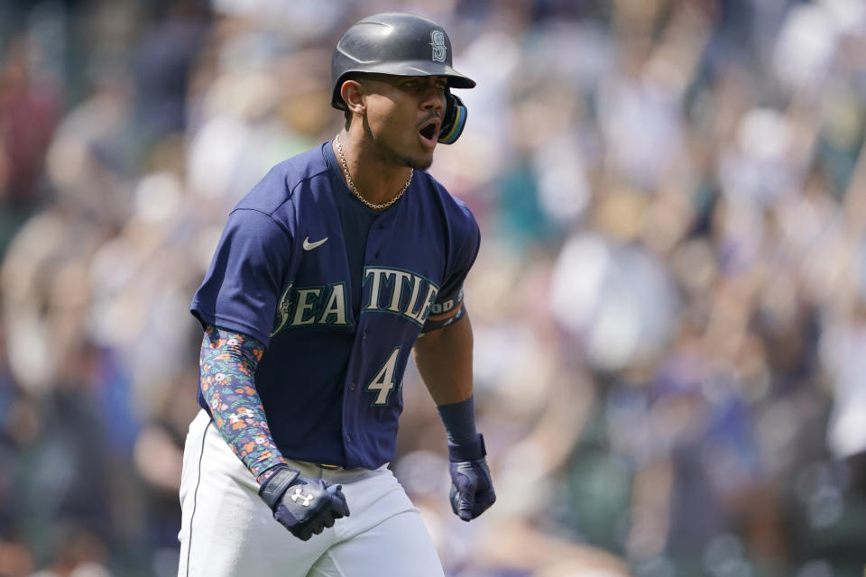 Seattle Mariners' Julio Rodriguez reacts as he heads to first base after hitting a three-run home run against the Texas Rangers during the seventh inning of a baseball game, Wednesday, July 27, 2022, in Seattle. (AP Photo/Ted S. Warren)