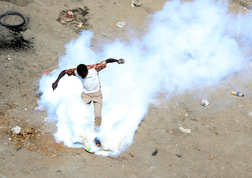 A protester caught in a cloud of tear gas during a mass rally called by the opposition leader Raila Odinga over the high cost of living in Nairobi, Kenya, on March 27, 2023. 