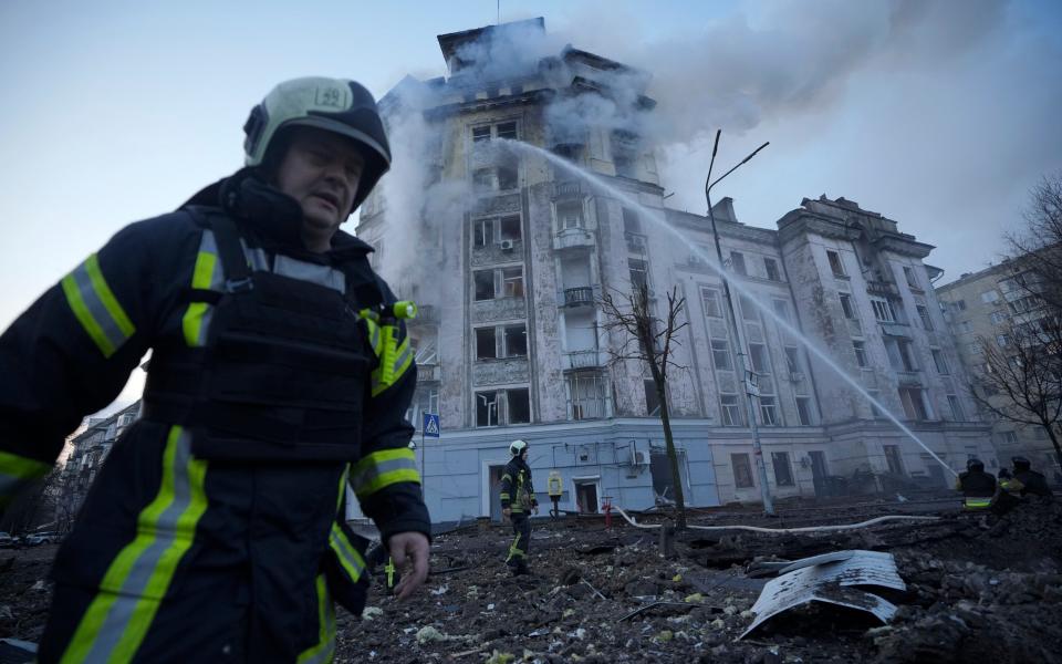 Firemen work at the site of a Russian attack on Kyiv