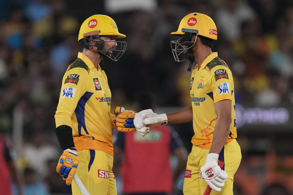 Chennai Super Kings' Devon Conway, left, and Ruturaj Gaikwad celebrate scoring runs during the Indian Premier League final cricket match between Chennai Super Kings and Gujarat Titans in Ahmedabad, India, Monday, May 29, 2023. (AP Photo/Ajit Solanki)