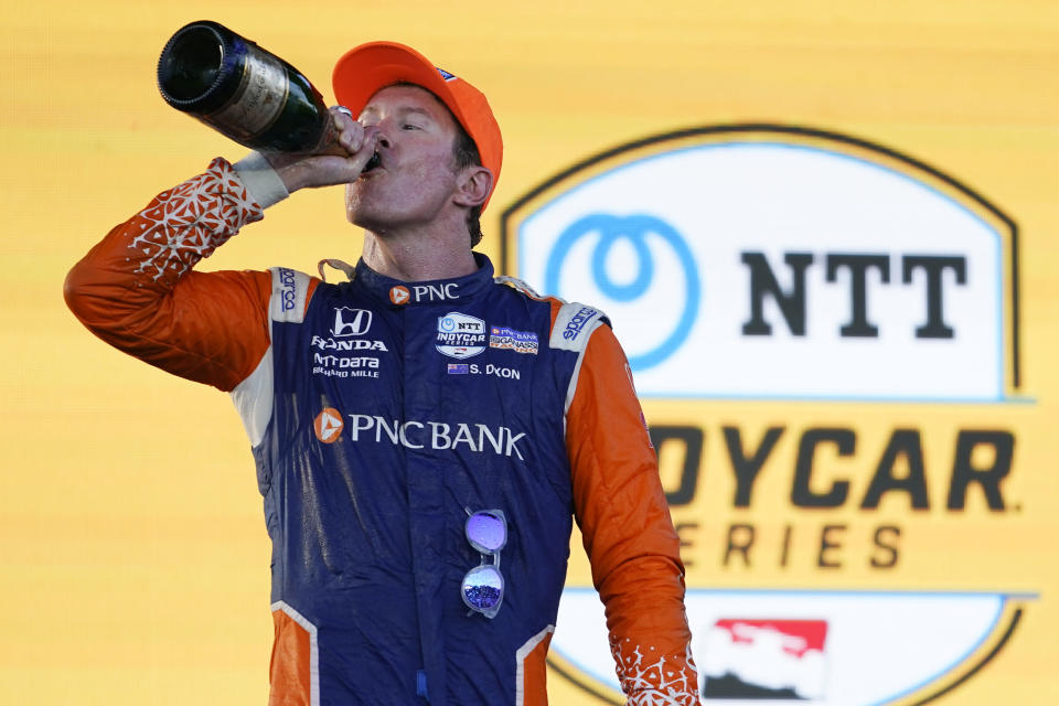 Scott Dixon takes a drink of champagne after winning the Music City Grand Prix auto race Sunday, Aug. 7, 2022, in Nashville, Tenn. (AP Photo/Mark Humphrey)