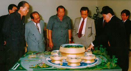 A 1998 handout image obtained from MKP's Company Profile booklet shows Malaysian Prime Minister Mahathir Mohamad looking at a model of the Kedah Padi Museum project which the Malaysia-Korea Partners (MKP) helped build. Malaysia-Korea Partners (MKP)/Handout via REUTERS