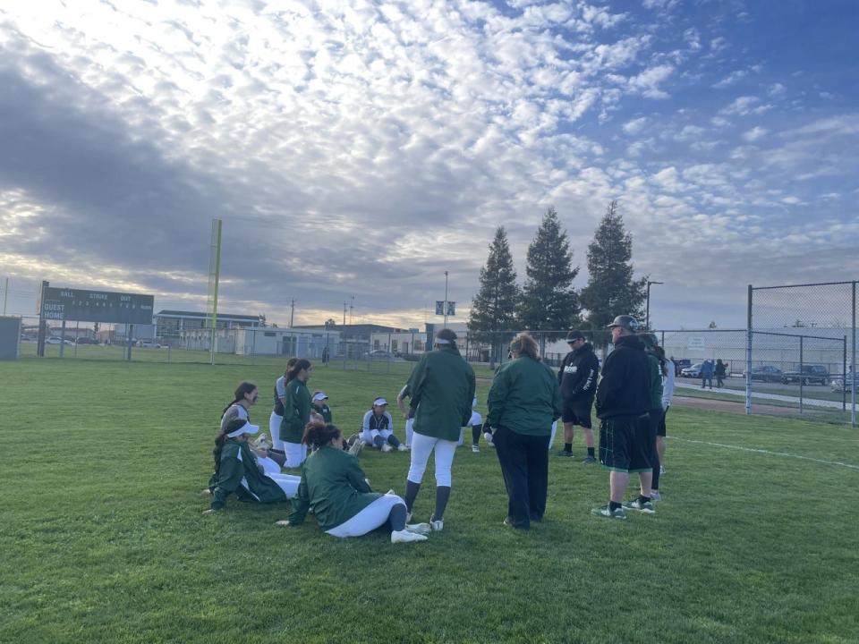 Manteca softball players and coaches sits and circle after Monday's loss against Ripon at Manteca High School.