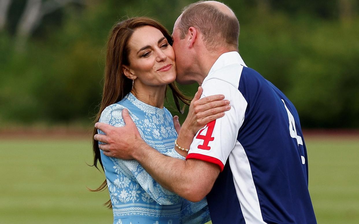 The Prince of Wales kisses his wife at last year's charity polo match