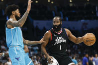 Los Angeles Clippers guard James Harden (1) runs the offense against Charlotte Hornets center Nick Richards during the first half of an NBA basketball game in Charlotte, N.C., Sunday, March 31, 2024. (AP Photo/Nell Redmond)