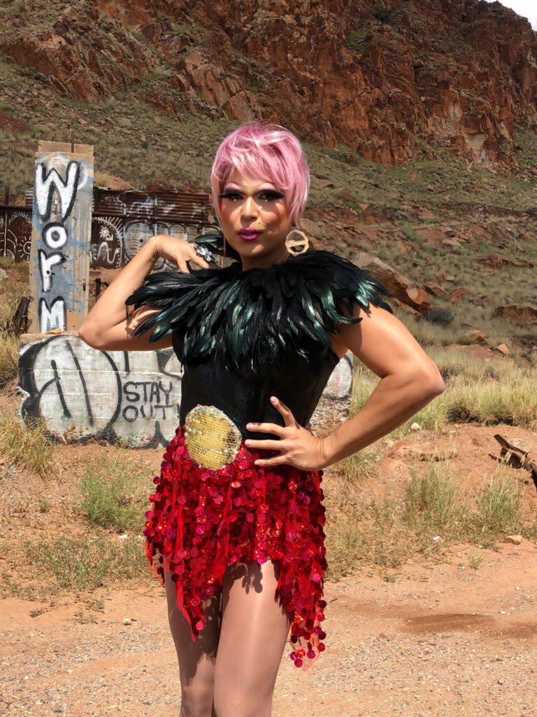 A drag queen standing in the Australian outback