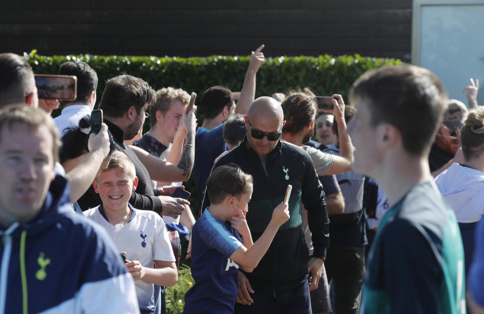 Fans cheers as soccer player Gareth Bale arrives at the training ground of Tottenham Hotspur in London, Friday Sept. 18, 2020. Real Madrid winger Gareth Bale is in London to complete his return to Tottenham. Bale left Tottenham for Madrid in 2013 for 100 million euros. (AP Photo/Frank Augstein)