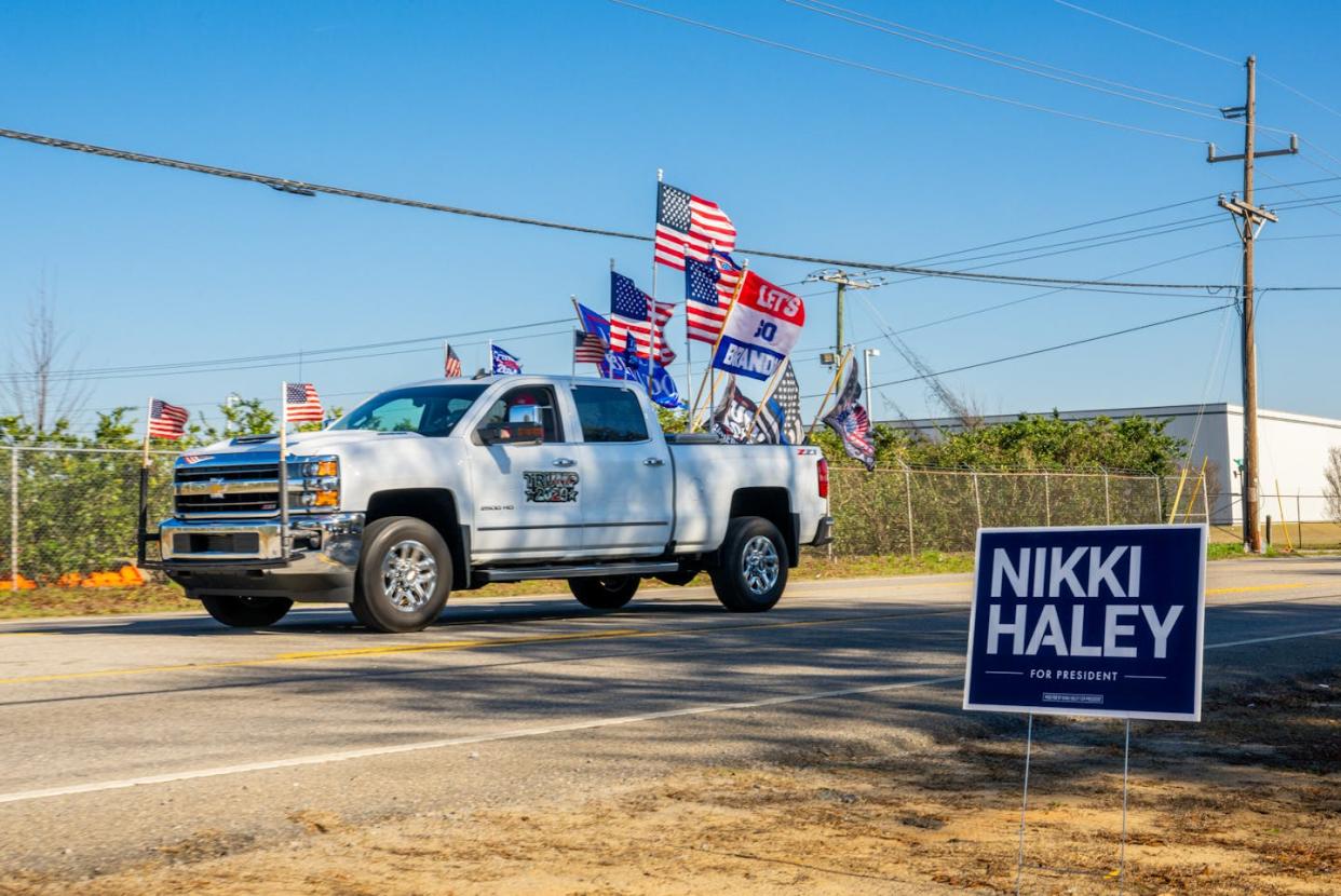 Donald Trump supporters drive by a rally for Nikki Haley on Feb.1, 2024, in Columbia, S.C. <a href="https://www.gettyimages.com/detail/news-photo/flag-festooned-truck-in-support-of-former-president-donald-news-photo/1978923483?adppopup=true" rel="nofollow noopener" target="_blank" data-ylk="slk:Brandon Bell/Getty Images;elm:context_link;itc:0;sec:content-canvas" class="link ">Brandon Bell/Getty Images</a>