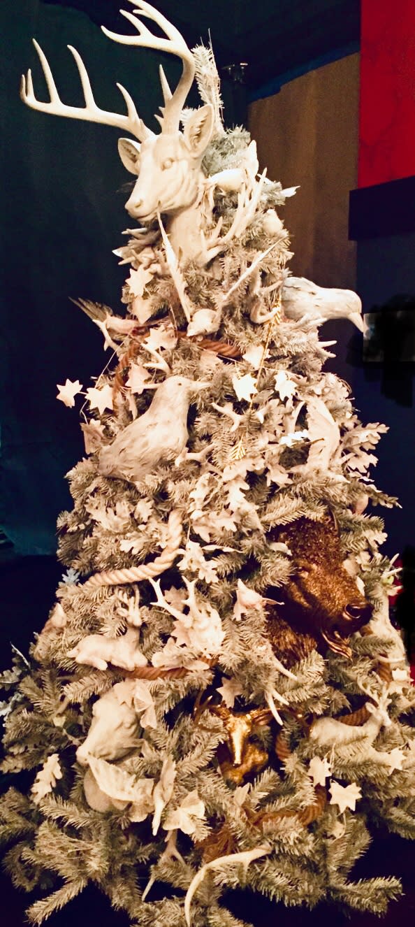 <p>Resin animals and antlers — along with a leaf garland and even the faux tree itself — were sprayed with white chalk paint for a winter wonderland effect. Interior designer <a rel="nofollow noopener" href="http://www.jessicabeckerdesigns.com/" target="_blank" data-ylk="slk:Jessica Becker;elm:context_link;itc:0;sec:content-canvas" class="link ">Jessica Becker</a> also added a thick rope to further the rustic vibe. Lit from within, the tree looks otherworldly.<br>(Photo courtesy of Jessica Becker) </p>