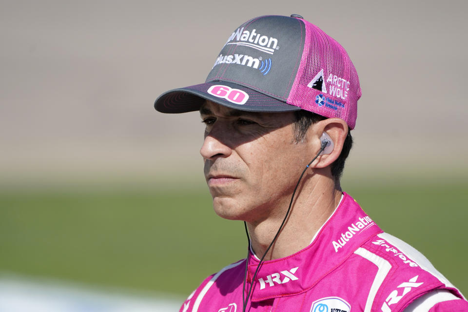 Hello Castroneves, of Brazil, stands near his care during qualifying for an IndyCar Series auto race, Saturday, July 23, 2022, at Iowa Speedway in Newton, Iowa. (AP Photo/Charlie Neibergall)