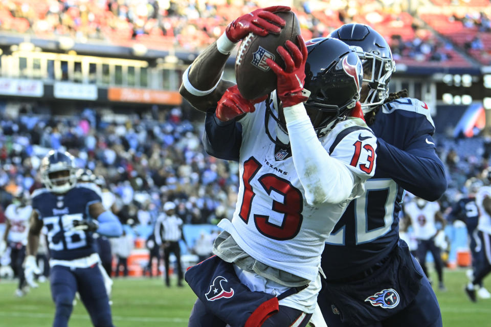 Houston Texans wide receiver Brandin Cooks (13) makes a touchdown catch against Tennessee Titans cornerback Lonnie Johnson Jr. (20) during the second half of an NFL football game, Saturday, Dec. 24, 2022, in Nashville, Tenn. (AP Photo/John Amis)