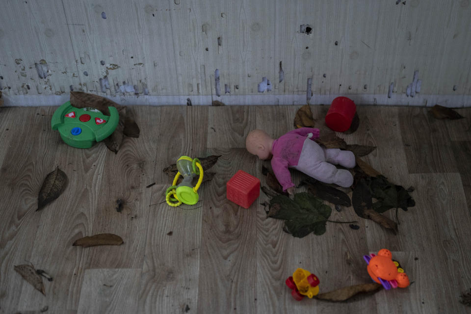 Toys and a doll lay on the floor of a playhouse in the courtyard of Kherson regional children's home in Kherson, southern Ukraine, Friday, Nov. 25, 2022. Throughout the war in Ukraine, Russian authorities have been accused of deporting Ukrainian children to Russia or Russian-held territories to raise them as their own. At least 1,000 children were seized from schools and orphanages in the Kherson region during Russia’s eight-month occupation of the area, their whereabouts still unknown. (AP Photo/Bernat Armangue)