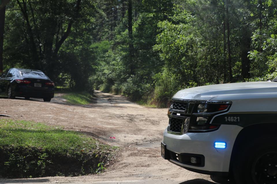 A sheriff blocking off the road leading to Waterfront Road, where a woman shot at police before killing herself, on Thursday April 28, 2022.