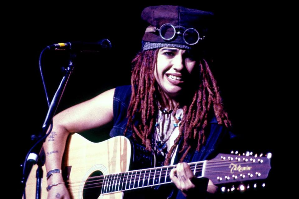 <p>Lester Cohen/Getty</p> Linda Perry performing in 4 Non Blondes in Los Angeles ca. 1990