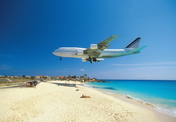 Airplane coming in for a landing just above the sunny beaches of St. Maarten.