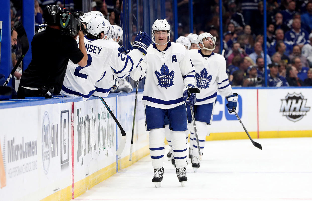 Jan 17, 2019; Tampa, FL, USA; Toronto Maple Leafs center Patrick Marleau (12) is congratulated after scoring a goal against the Tampa Bay Lightning during the second period at Amalie Arena. Mandatory Credit: Kim Klement-USA TODAY Sports