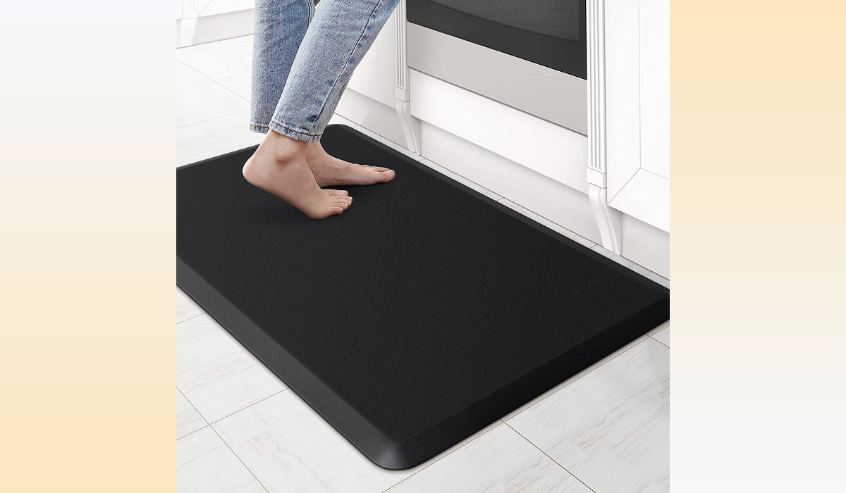 Feet on the black kitchen mat