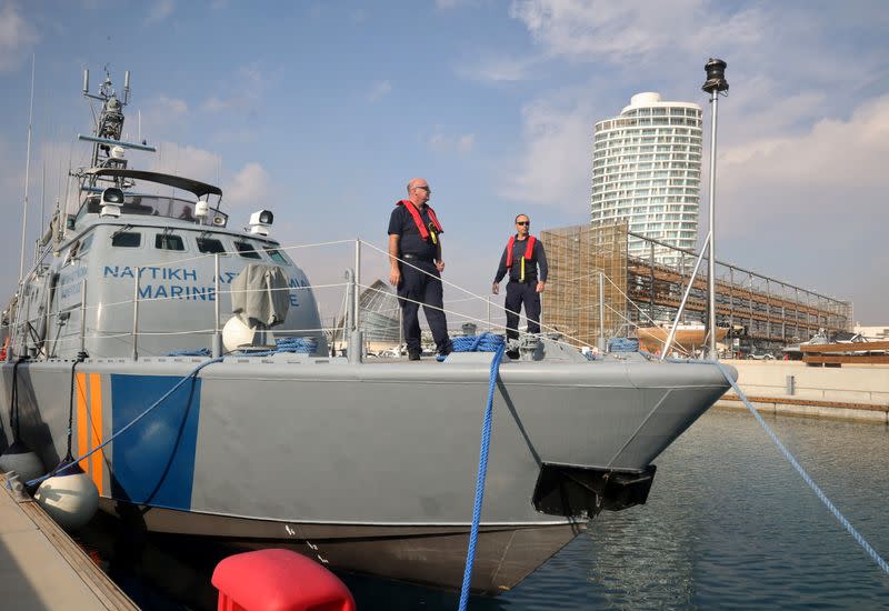 Officers stand on a Cyprus Port and Marine Police vessel in Ayia Napa Marina