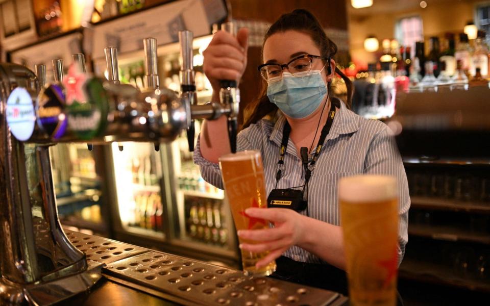 Pubs, restaurants, cafés and bars will be able to open indoors in step three of lockdown easing  -  OLI SCARFF / AFP