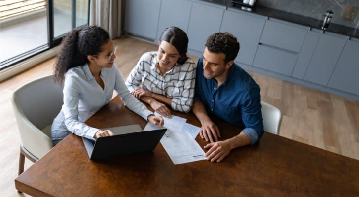 A financial advisor talks with a couple about the annual reset of their fixed index annuity.