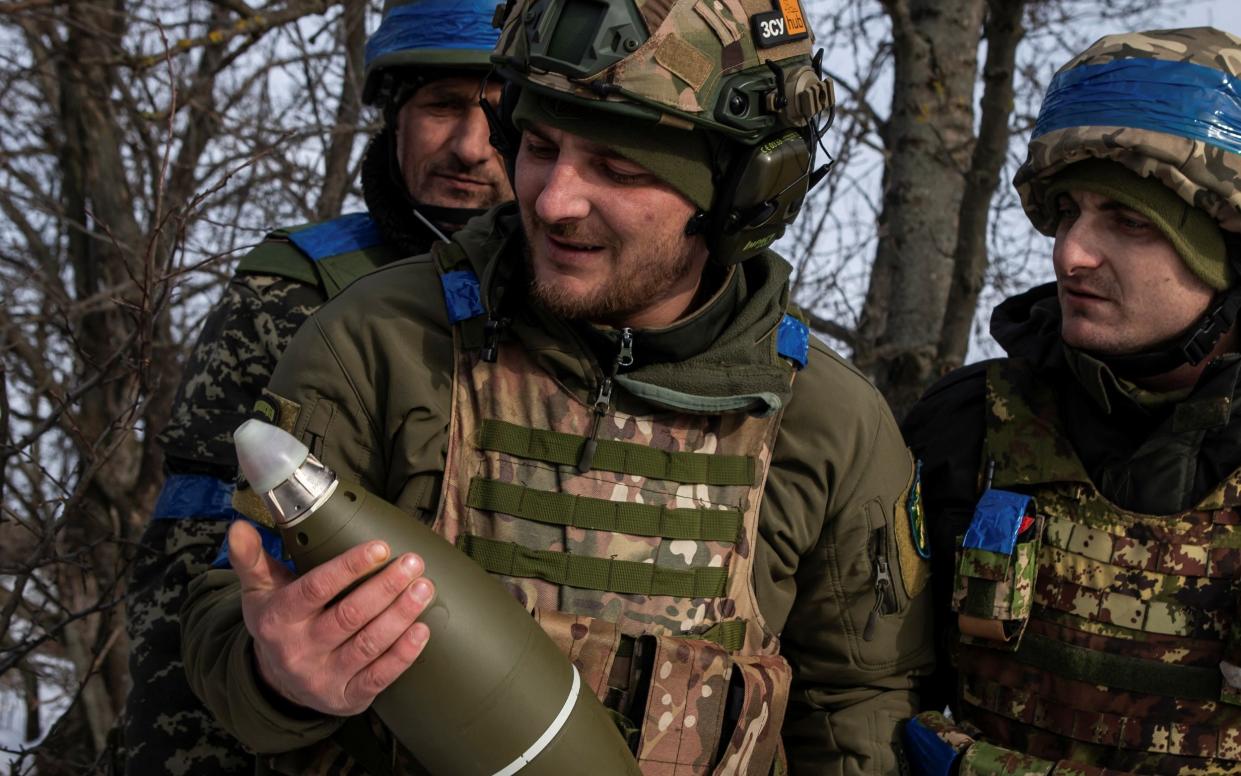 Ukrainian service members look at a mortar shell before firing towards Russian troops in frontline near the Vuhledar town - REUTERS
