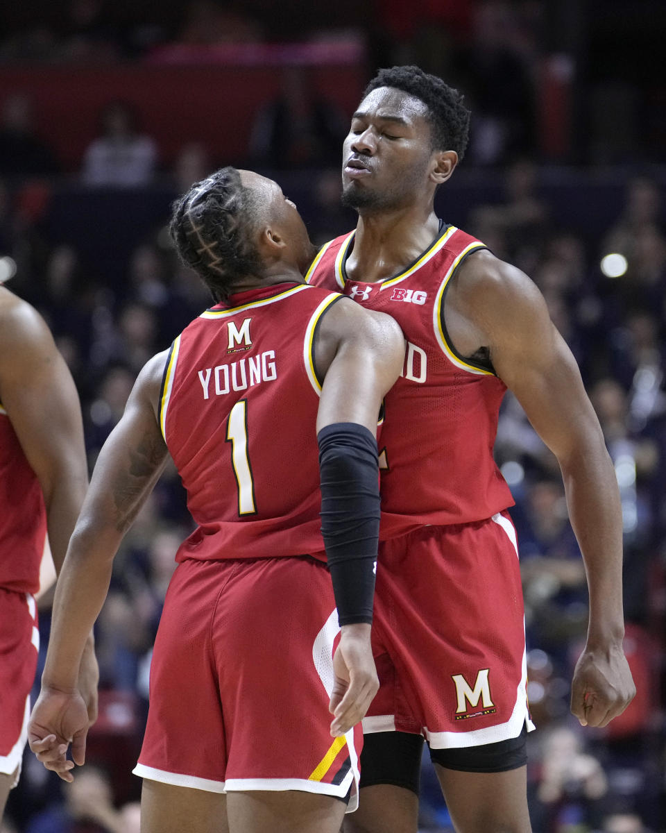 Maryland's Jahmir Young, left, and Jordan Geronimo begin to celebrate the team's 76-67 upset win over Illinois late in the second half of an NCAA college basketball game Sunday, Jan. 14, 2024, in Champaign, Ill. (AP Photo/Charles Rex Arbogast)