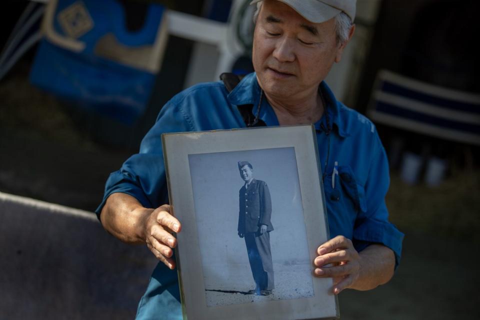 Darrell Kunitomi holds a photograph of his uncle while on a tour of Santa Anita Park.