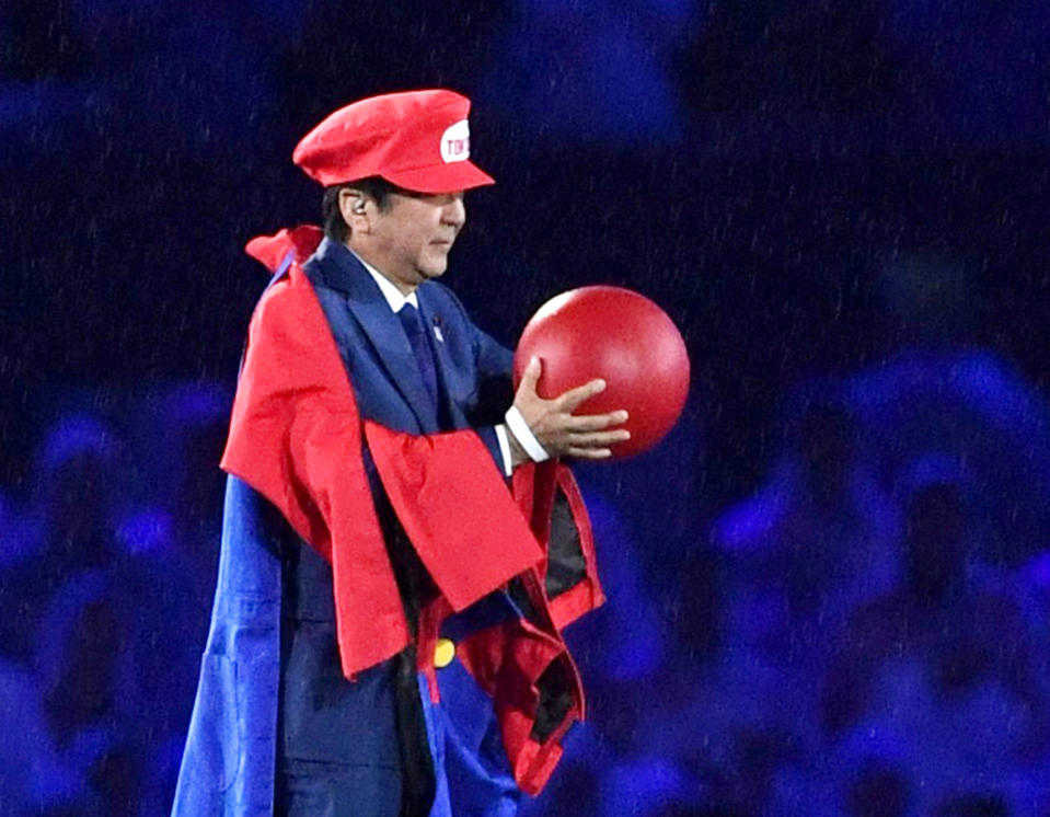 FILE - In this Aug. 21, 2016, file photo, Japanese Prime Minister Shinzo Abe appears as the Nintendo game character Super Mario during the closing ceremony at the 2016 Summer Olympics in Rio de Janeiro, Brazil. Abe was a star of the closing ceremony of the 2016 Rio de Janeiro Olympics, parading before a 70,000 sellout at the Maracana stadium as Nintendo game character Super Mario. It was Abe's humorous invitation to the next Olympics in Tokyo. (Yu Nakajima/Kyodo News via AP, File)