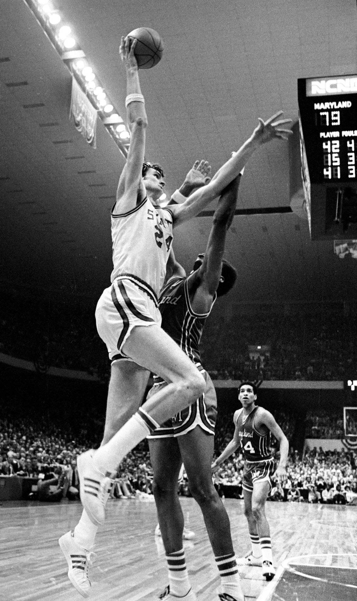 NC State center Tommy Burleson goes up for a shot over Maryland center Len Elmore late in the Wolfpack’s ACC Tournament game against Maryland in 1974.