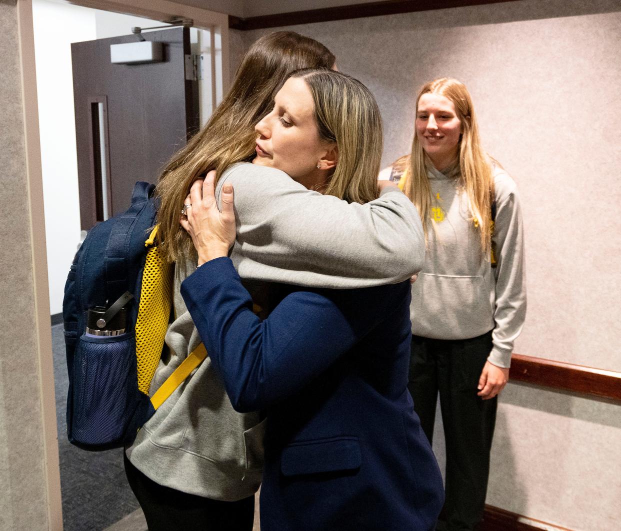 Cara Consuegra hugs the players Thursday during her introduction as Marquette's new women's basketball coach.