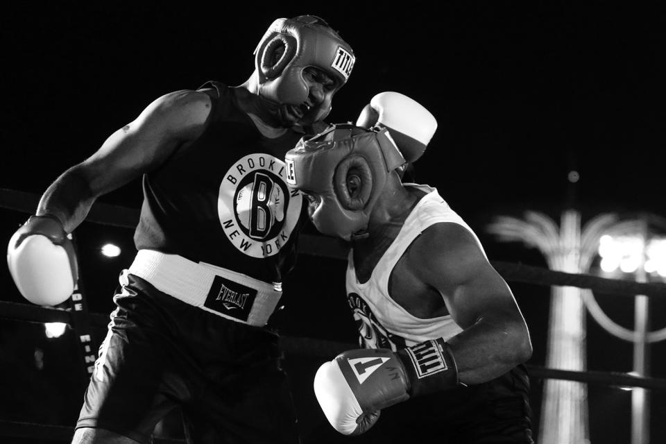 <p>Wayne Lowe and Brian Davis, both from the 28th Precinct in Harlem, mix it up during a grudge match at the Brooklyn Smoker in the parking lot of Gargiulo’s Italian restaurant in Coney Island, Brooklyn, on Aug. 24, 2017. (Photo: Gordon Donovan/Yahoo News) </p>