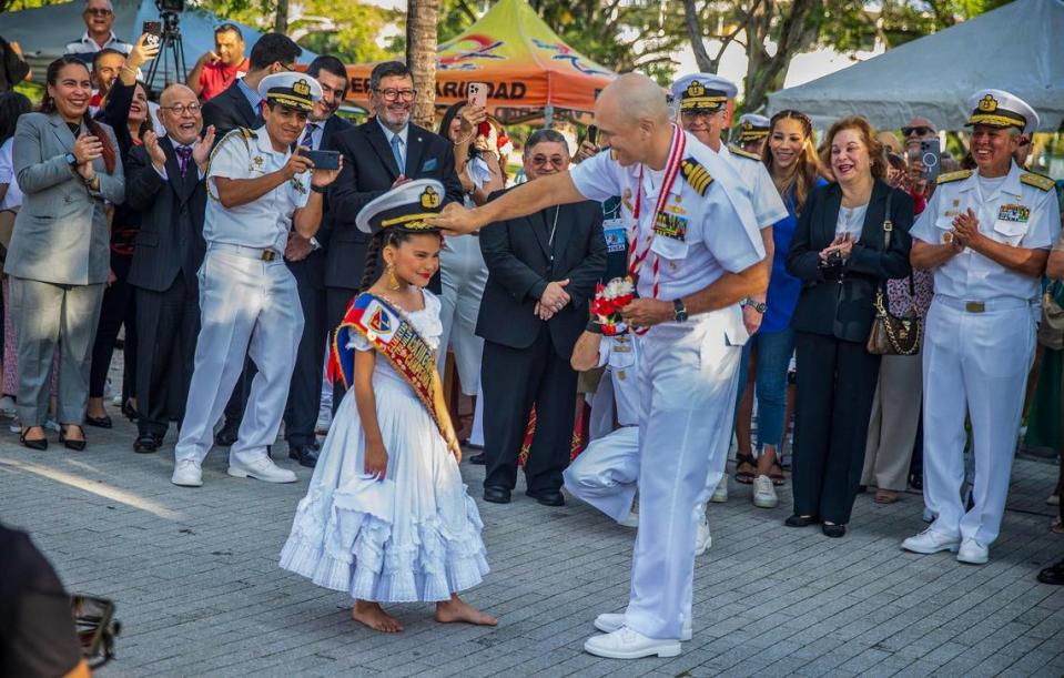 Captain José Luis Arce Corzo, the B.A.P. Unión Commanding Officer, exchanges his Capt. navy hat with Rafaella “Gotita” Aguinada who welcomed him with flowers bouquet.