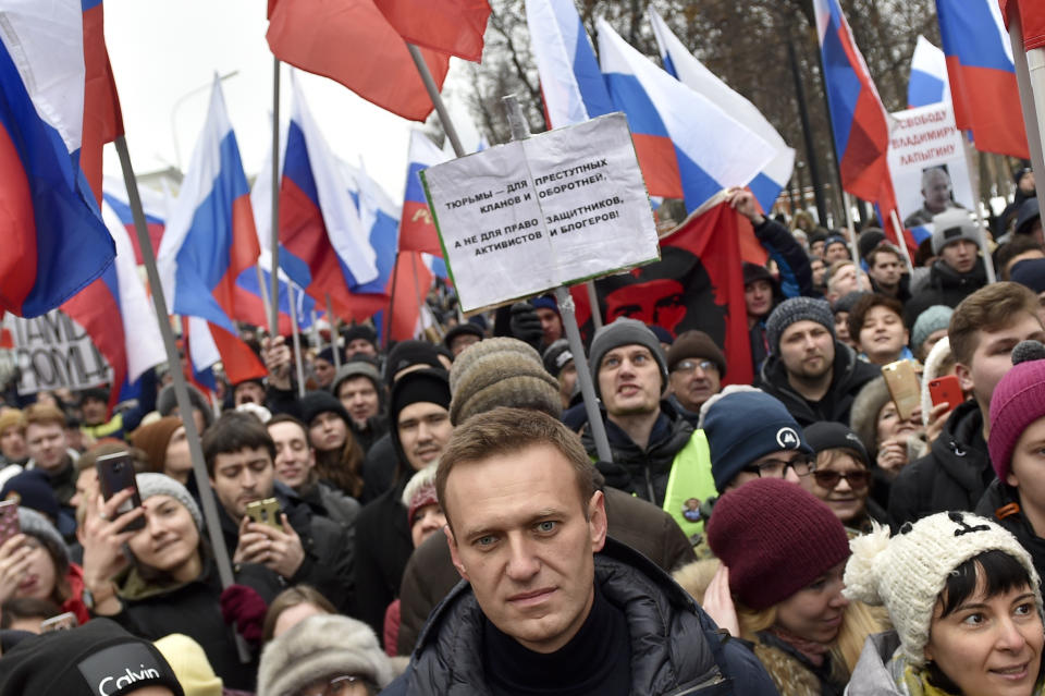 Russian opposition activist Alexei Navalny, center, takes part in a march in memory of opposition leader Boris Nemtsov in Moscow, Russia, Sunday, Feb. 24, 2019. Thousands of Russians took to the streets of downtown Moscow to mark four years since Nemtsov was gunned down outside the Kremlin. (AP Photo/Dmitry Serebryakov)