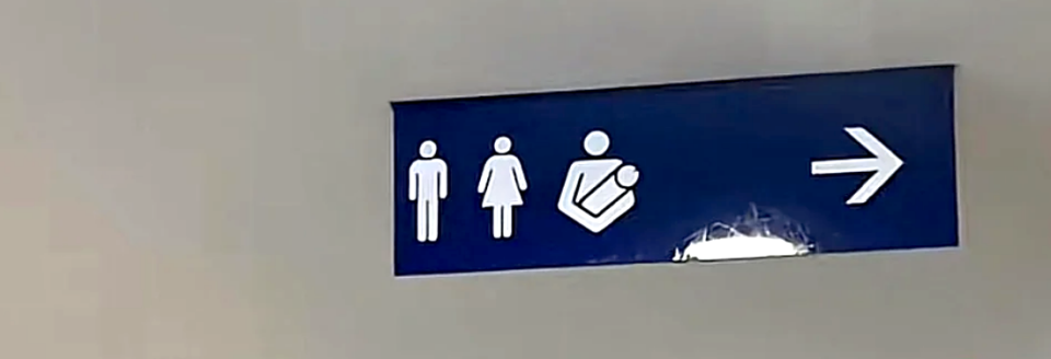sign looks like the guy is holding his penis