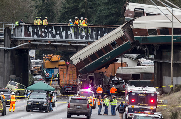 Emergency crews work at the scene of a Amtrak train derailment on December 18, 2017, 2017 in DuPont, Washington. At least six people were killed when a train car plunged from a bridge closing the I-5 southbound. (Photo by Stephen Brashear/Getty Images)