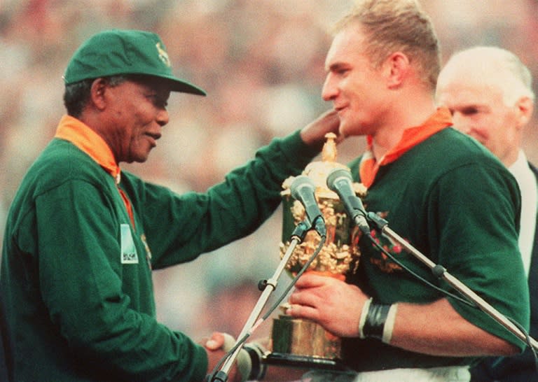 Then South African rugby captain Francois Pienaar (R) is congratulated by the country's president of the time Nelson Mandela after winning the 1995 World Cup in Johannesburg