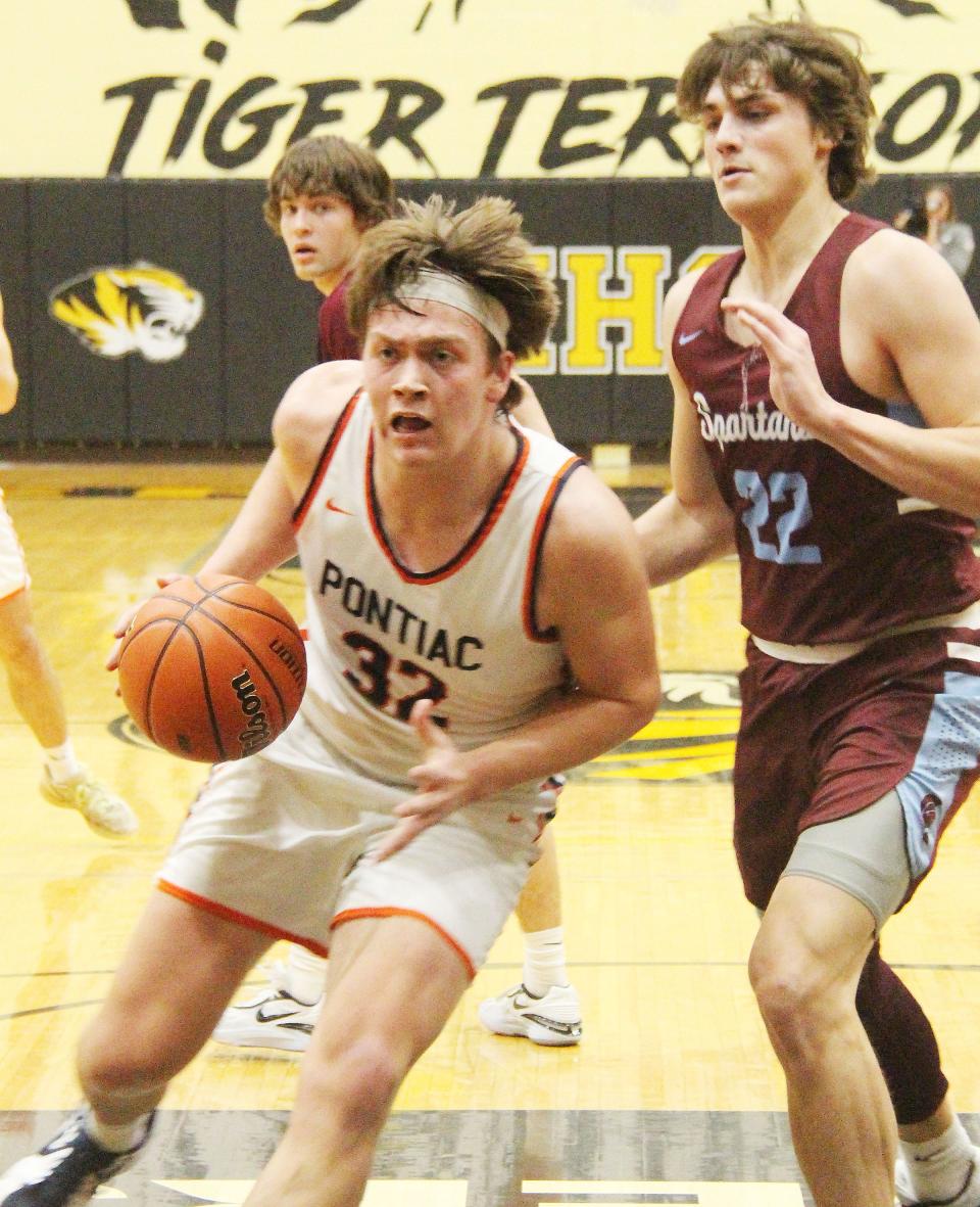 Pontiac senior Logan Barnett drives past St. Joseph-Ogden defender Ty Pence during Tuesday's Class 2A sectional semifinal game at Herscher. Barnett scored 8 points in the Indians' 55-40 victory.