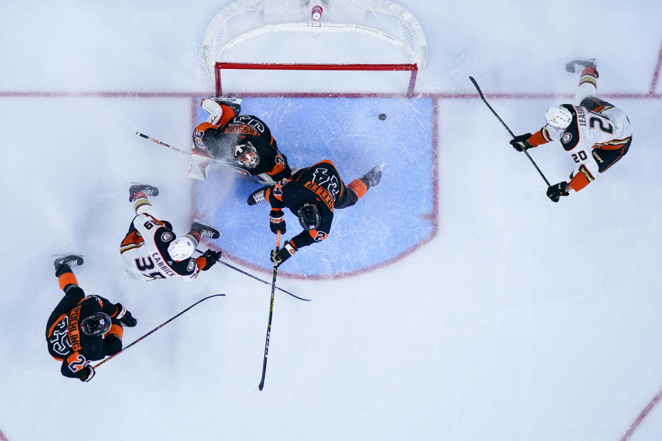 Anaheim Ducks' Brett Leason, right, shots the puck past Philadelphia Flyers' Samuel Ersson, center for a goal during the third period of an NHL hockey game, Saturday, Oct. 28, 2023, in Philadelphia. The Ducks won 7-4. (AP Photo/Chris Szagola)