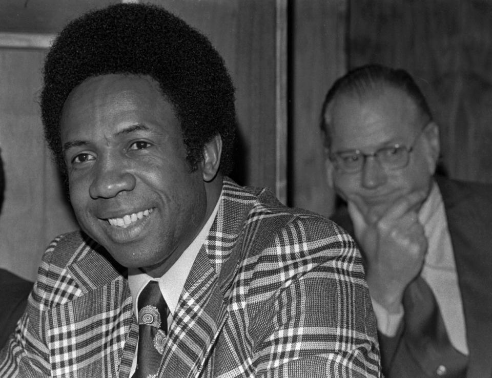 FILE - This June 19, 1996, file photo shows Frank Robinson at a news conference in Cleveland, Ohio, after being named Major League Baseball's first black manager, with the Cleveland Indians. In the background is baseball commissioner Bowie Kuhn. Hall of Famer Frank Robinson, the first black manager in Major League Baseball and the only player to win the MVP award in both leagues, has died. He was 83. Robinson had been in hospice care at his home in Bel Air. MLB confirmed his death Thursday, Feb. 7, 2019. (AP Photo/File)