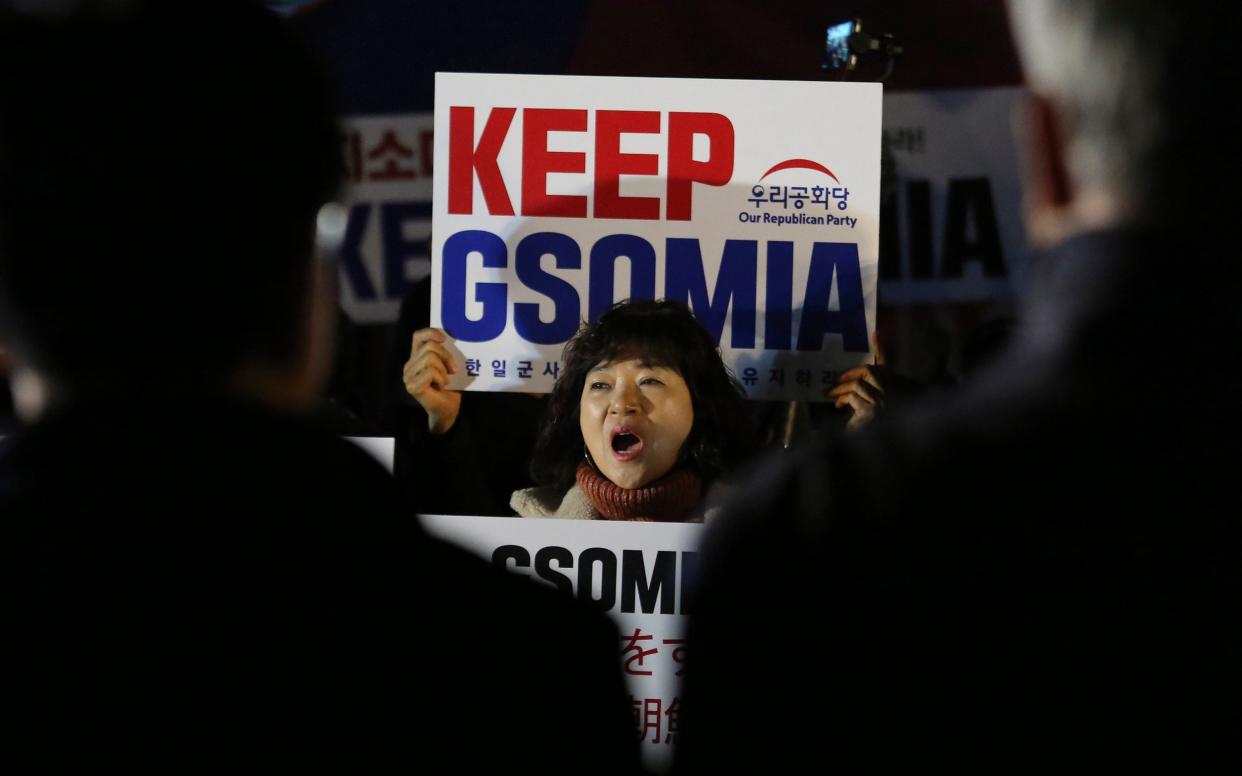 A woman opposing South Korean President Moon Jae-in shouts during a rally demanding the South Korean government to keep the General Security of Military Information Agreement, or GSOMIA, an intelligence-sharing agreement between South Korea and Japan, that was ultimately salvaged last-minute - AP