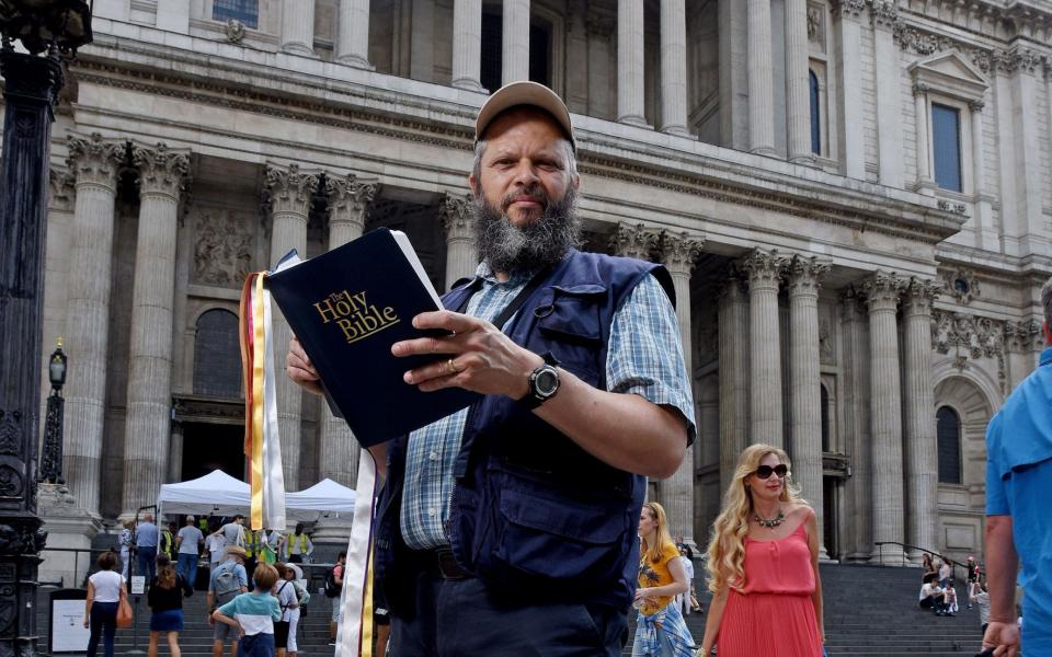 Bus driver Alan Coote preaches outside St Paul's cathedral. - Not known