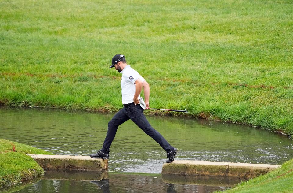 Jun 2, 2022; Dublin, Ohio, USA; Adam Hadwin walks across the creek on the 14th hole during Round 1 of the Memorial Tournament at Muirfield Village Golf Club in Dublin, Ohio on June 2, 2022. 
