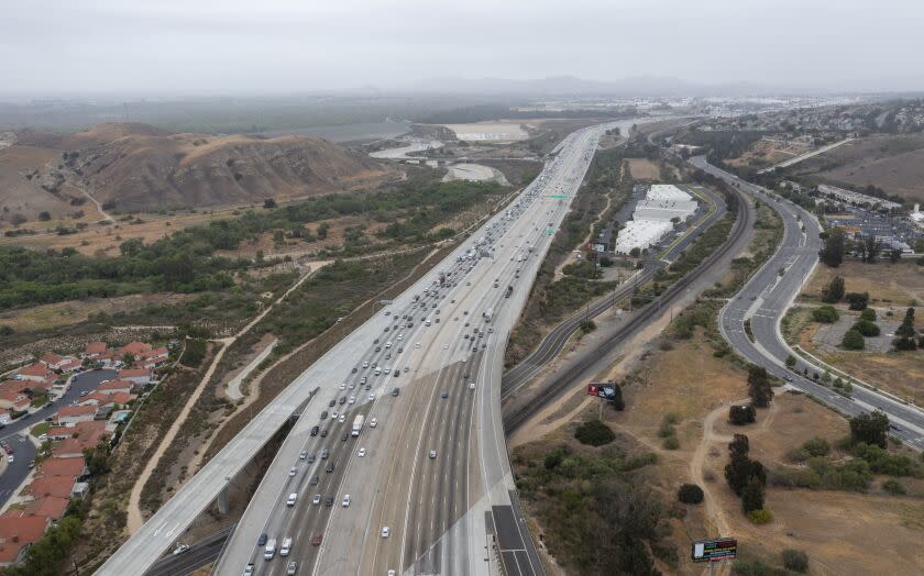 CORONA, CA - May 20: An aerial view of traffic on the 91 Freeway and the Green River Rd. overpass where there have been more than a dozen instances of cars having their windows shot out by bebe guns. Photo taken Thursday, May 20, 2021 in Corona, CA. At least four vehicles were shot at in Anaheim Thursday morning near the WB 91 Freeway. The windows of three cars were shot out on the 91 Freeway in Corona recently, the latest in a string of dozens of similar incidents, according to the California Highway Patrol. The CHP is now investigating roughly 50 shooting incidents that began in late April and have targeted cars traveling on the freeway in Riverside, Orange and Los Angeles counties. (Allen J. Schaben / Los Angeles Times)