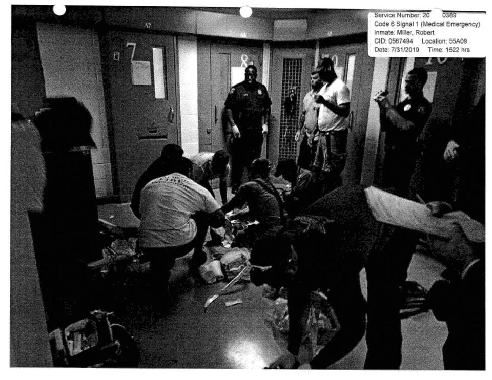 Medics treat Robert Miller in Tarrant County Jail after he was found unconscious. This image was included in the Texas Rangers investigative report.