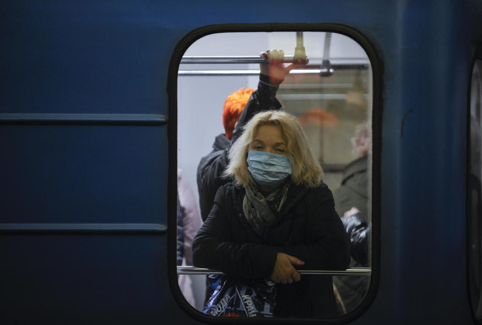  A woman wearing a protective mask as a precaution to the outbreak of Coronavirus rides on a subway in Kiev. The first case of coronavirus in Ukraine was recorded in Chernivtsi of a man who returned from Italy after a tourist trip. (Photo by Sergei Chuzavkov / SOPA Images/Sipa USA) 