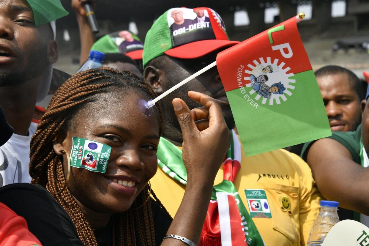 Young Nigerians rallying to support Labour candidate Peter Obi consider themselves part of the 'Obi-dient' movement. <a href="https://www.gettyimages.com/detail/news-photo/supporter-sticks-a-party-flag-to-her-face-during-campaign-news-photo/1247043117" rel="nofollow noopener" target="_blank" data-ylk="slk:Pius Utomi Ekpei/AFP via Getty Images;elm:context_link;itc:0;sec:content-canvas" class="link ">Pius Utomi Ekpei/AFP via Getty Images</a>