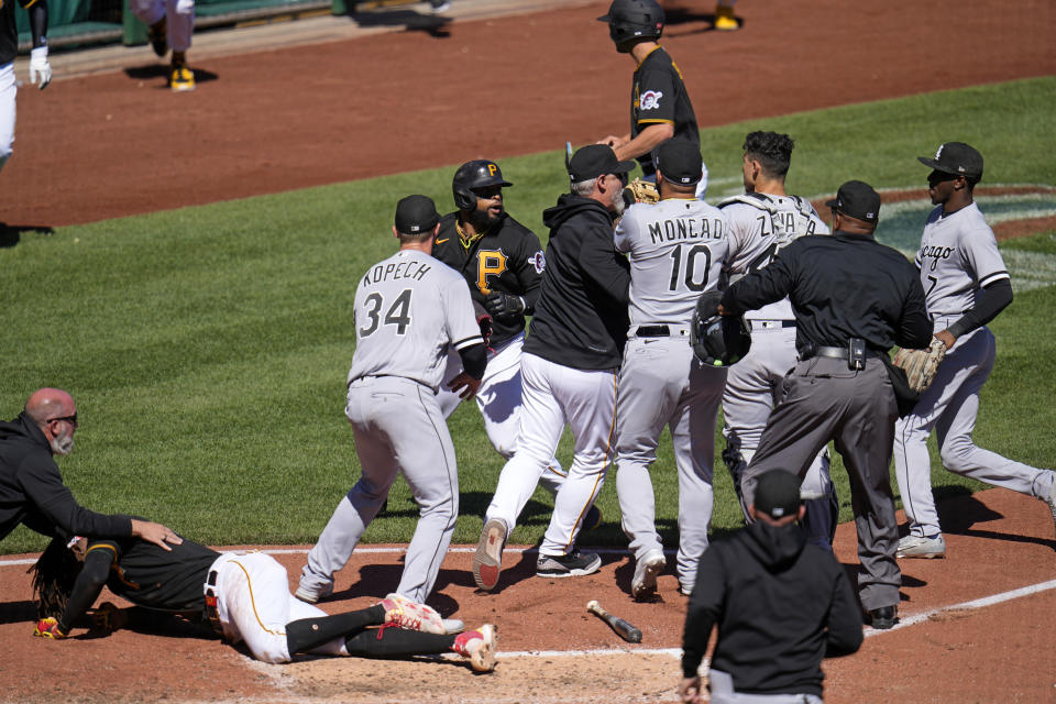 Pittsburgh Pirates' Oneil Cruz, on the ground left, is checked by a trainer after being injured in a collision with Chicago White Sox catcher Seby Zavala during the sixth inning of a baseball game in Pittsburgh, Sunday, April 9, 2023. A bench clearing brawl began as a result of the play. The Pirates won 1-0. (AP Photo/Gene J. Puskar)