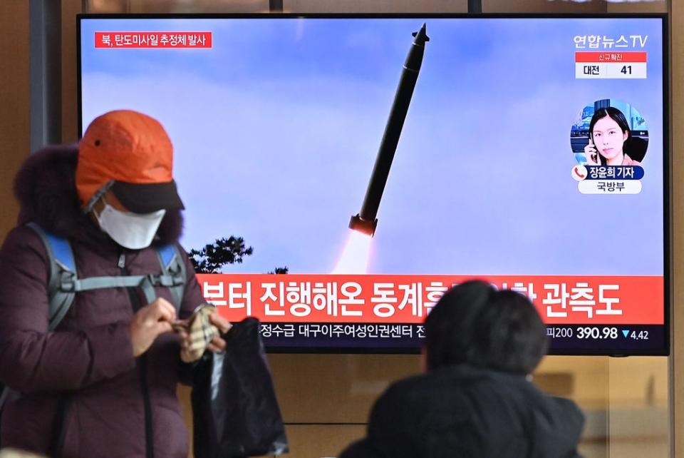 People watch a television news broadcast showing file footage of a North Korean missile test, at a railway station in Seoul (AFP via Getty Images)