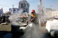 Demonstrator cooks during the ongoing anti-government protests in Baghdad